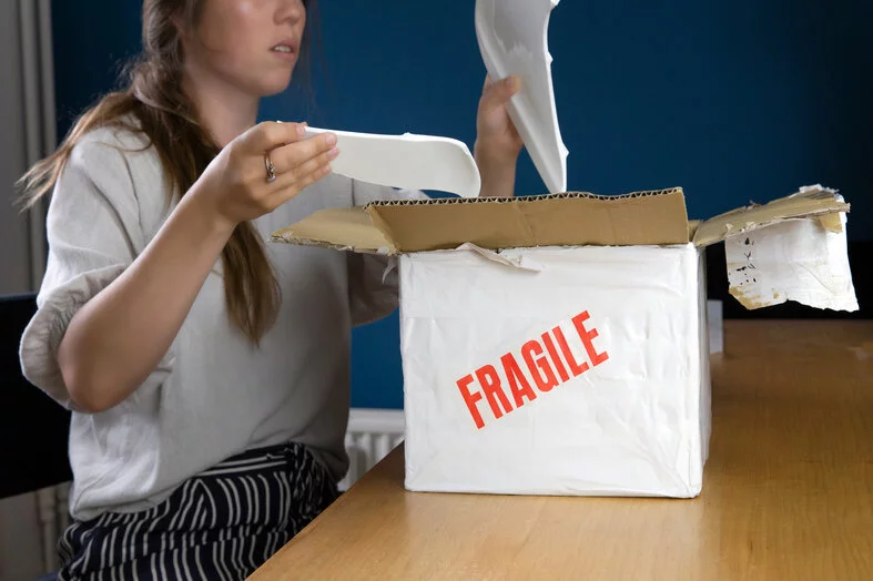 a women opening a damaged package