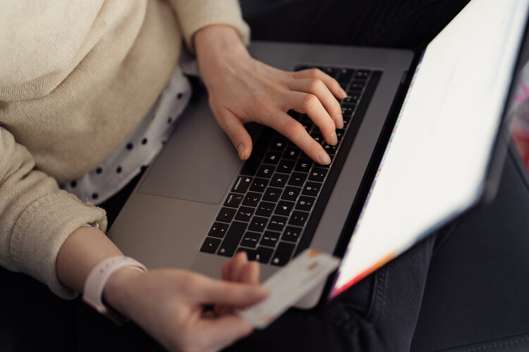 Women holding her credit card and shopping online on her lap top