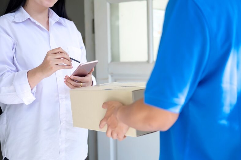 a woman accepting a package